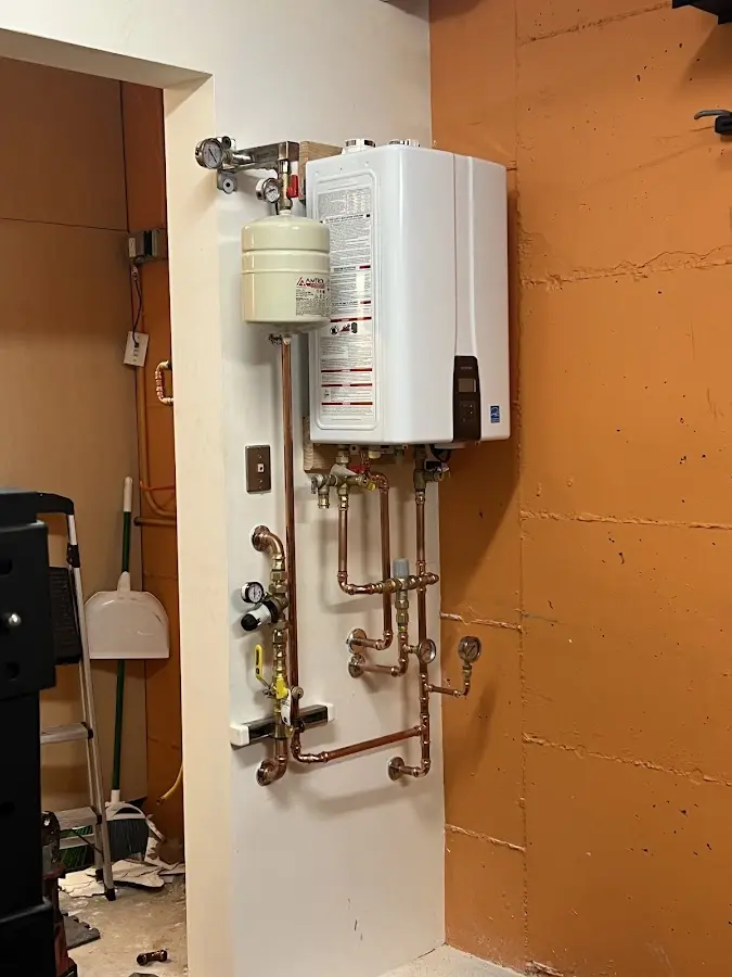 Plumbing technician inspecting water heater connections in Sierra Vista Southeast